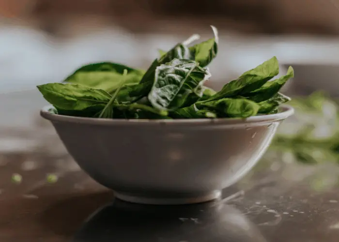 spinach leaves in a brown bowl