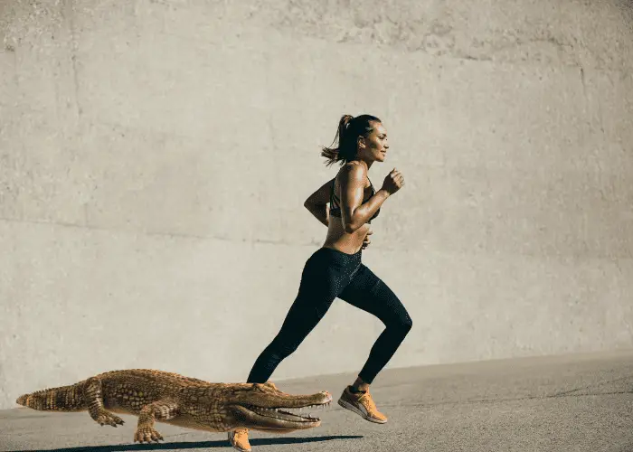 alligator running with a lady