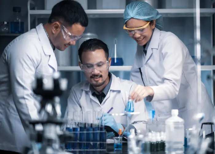 scientists studying a frog specimen